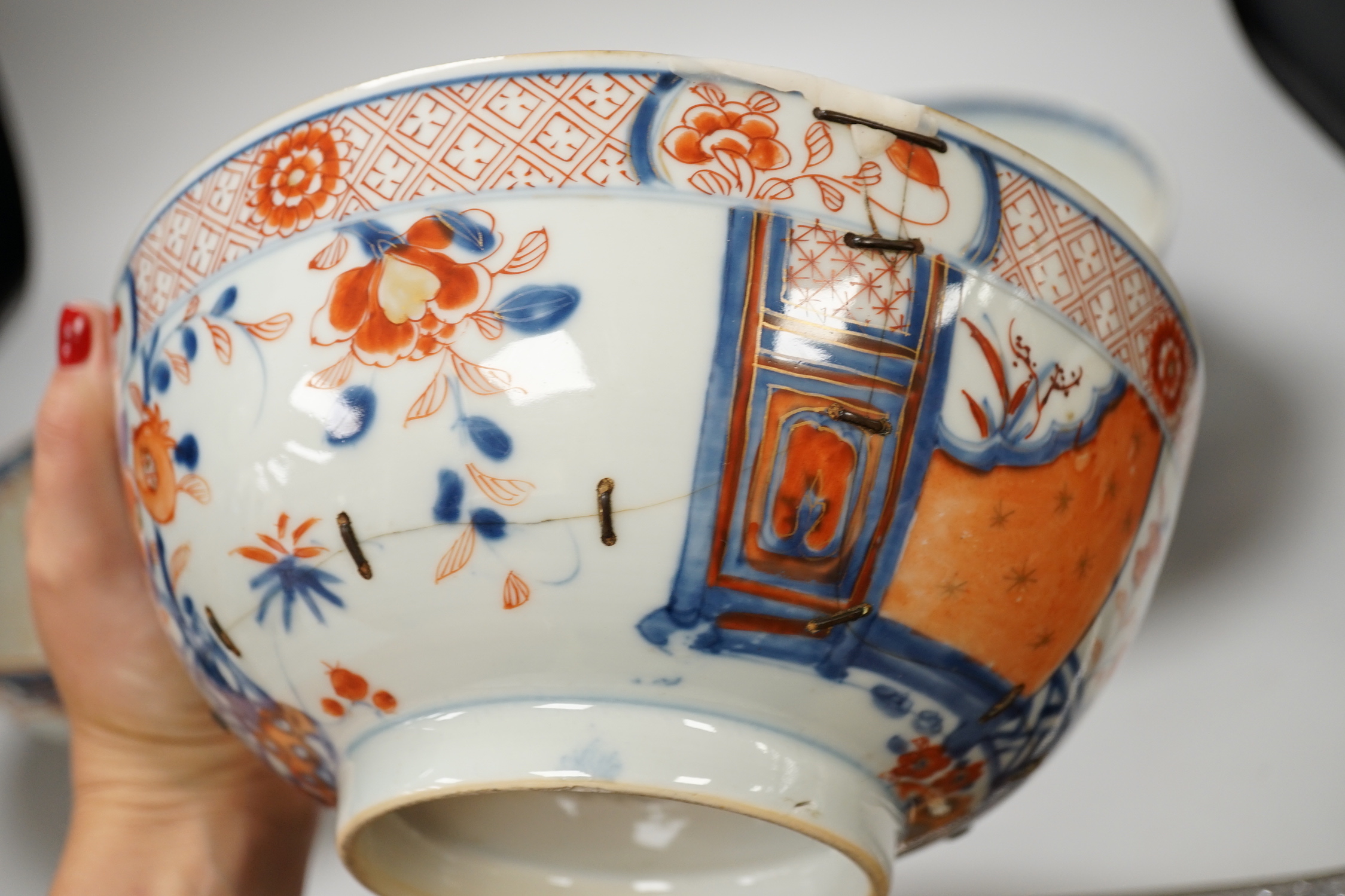 Four 18th century Chinese porcelain bowls (a.f), one with hardwood stand, largest 28cm diameter